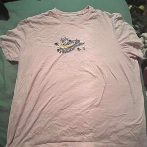 Nike friends collaboration. pink shirt with the designs on front and back
